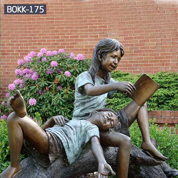 Girl is reading books for other girl bronze statues outdoor garden