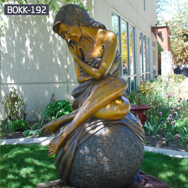 Life size woman sitting on a ball yard bronze sculptures outdoor