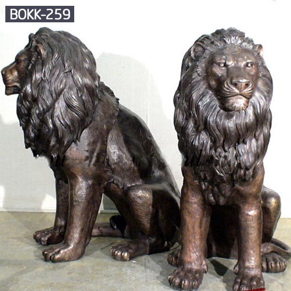 A pair of bronze sitting life size garden lion statues outdoor