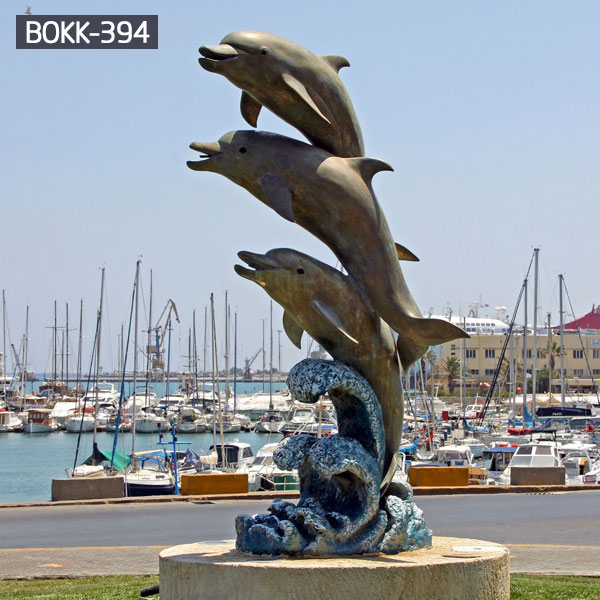 Metal bronze dolphin statues in the side of sea outdoor decoration